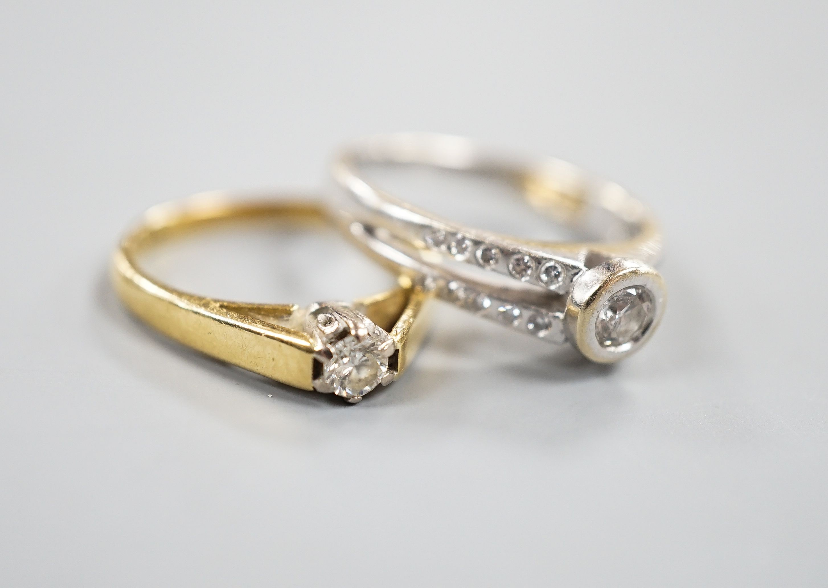 Two 18ct gold and diamond rings, including solitaire and white gold single stone, with diamond set shoulders, sizes, K & M, gross 6.5 grams.